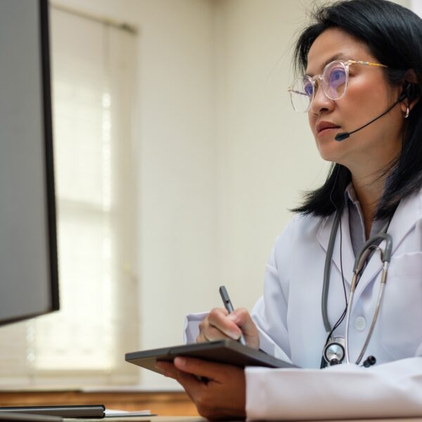 asian woman doctor visit patient video call online diagnose symptom at clinic